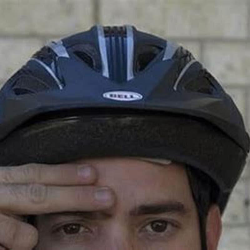 How far above the eyebrows should a helmet rest?